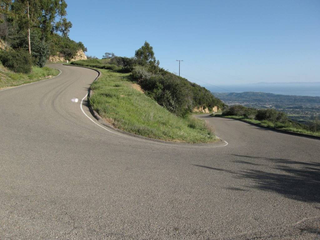 The road surface eventually gets nice: One of the many steep hairpins on the descent of Painted Cave Rd.