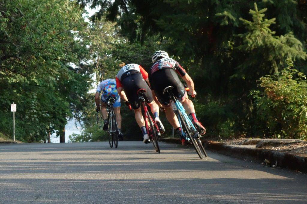 Riders in a breakaway accelerate into the backstretch.