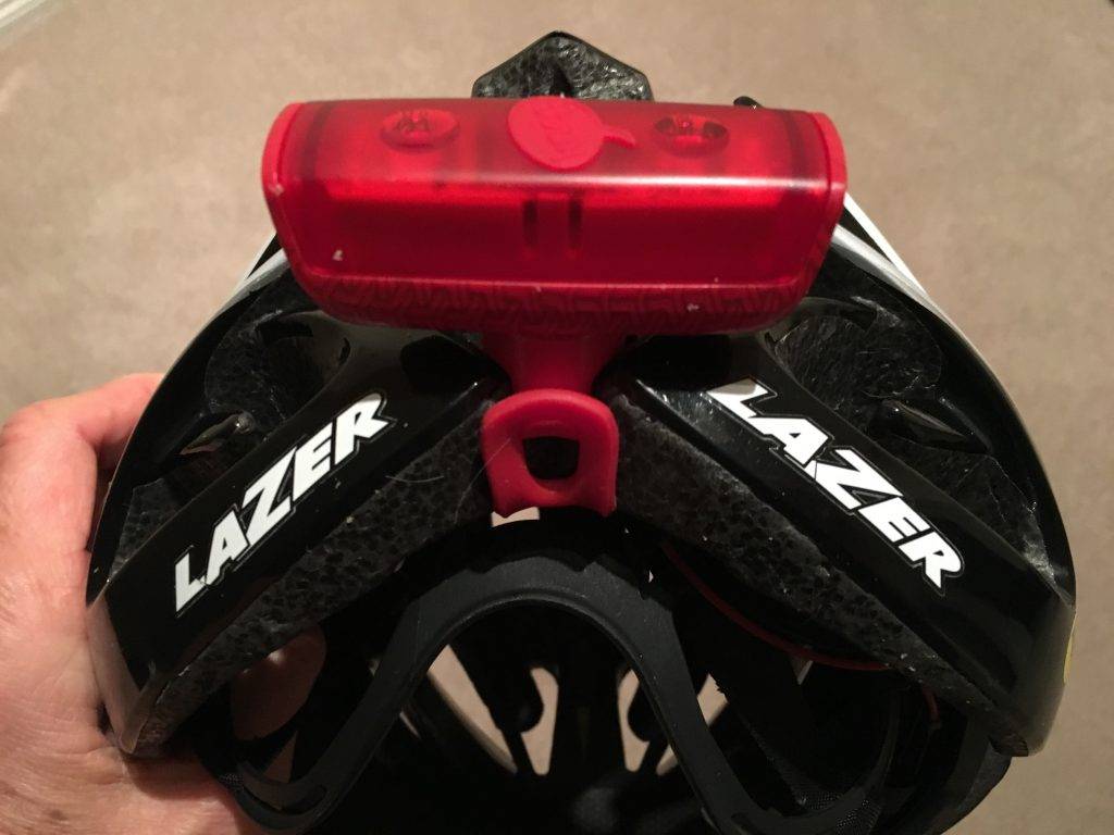 Attach a red light to the back of your helmet by looping the attachment strap through the vent holes.